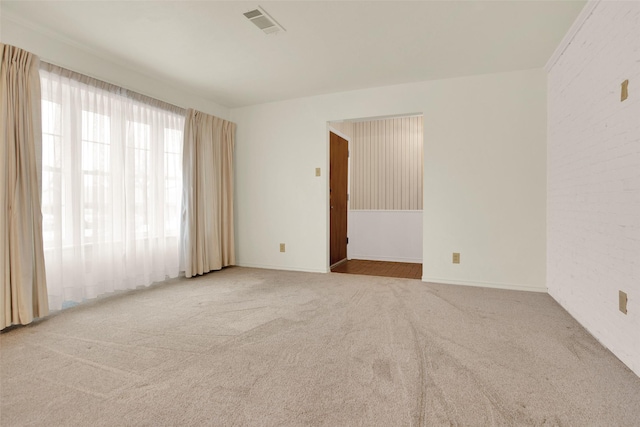 empty room with carpet floors and visible vents