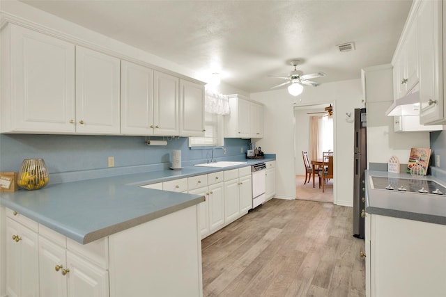 kitchen featuring light wood-style flooring, white cabinets, white dishwasher, a sink, and ceiling fan