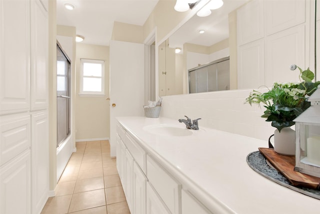 bathroom featuring tile patterned flooring, baseboards, and vanity