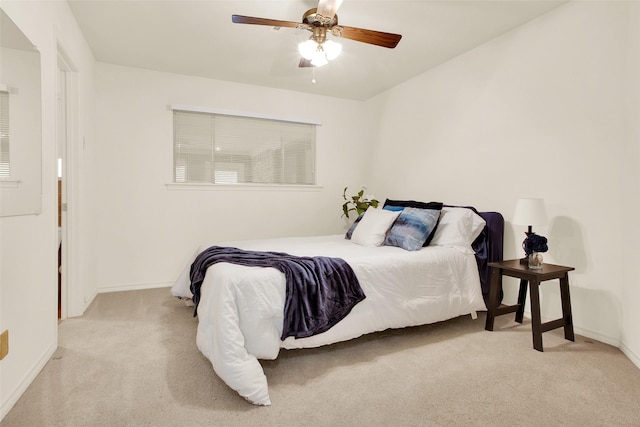 carpeted bedroom featuring ceiling fan and baseboards