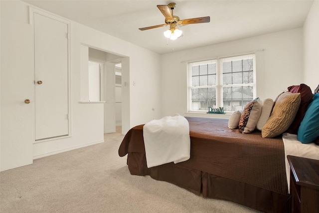 bedroom featuring ceiling fan and light colored carpet