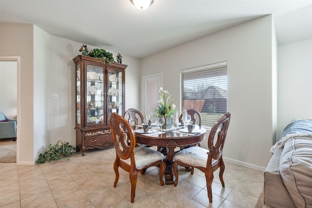 dining area with light tile patterned floors and baseboards