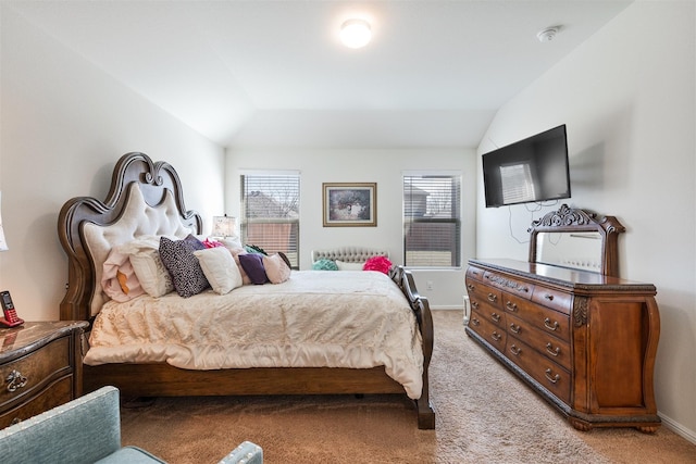 bedroom featuring lofted ceiling, light colored carpet, and baseboards