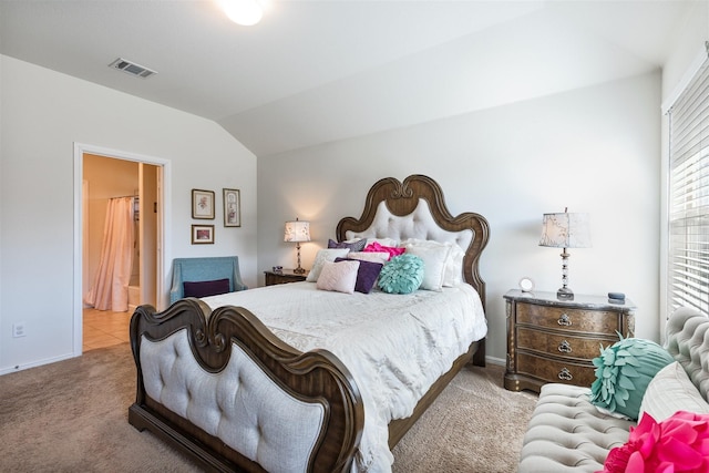 bedroom with visible vents, vaulted ceiling, and carpet flooring