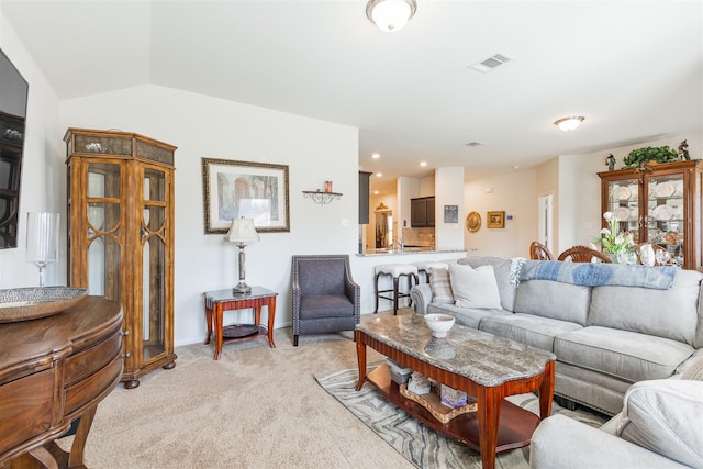 living room with lofted ceiling, recessed lighting, light carpet, visible vents, and baseboards