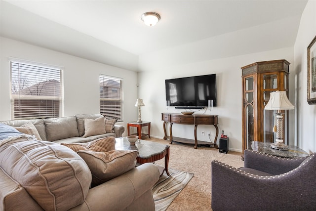 living area featuring carpet and baseboards