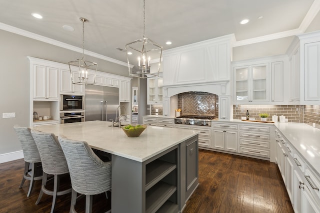 kitchen featuring appliances with stainless steel finishes, a sink, and white cabinetry