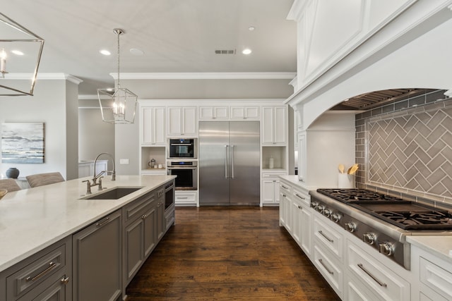 kitchen featuring gray cabinetry, a sink, visible vents, ornamental molding, and appliances with stainless steel finishes