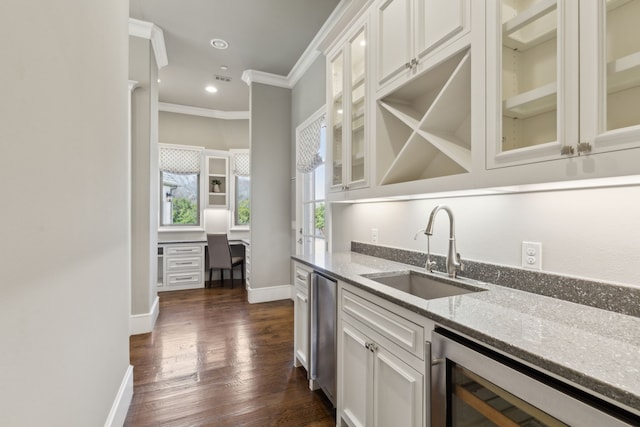 kitchen with dark wood-style flooring, crown molding, a sink, light stone countertops, and beverage cooler