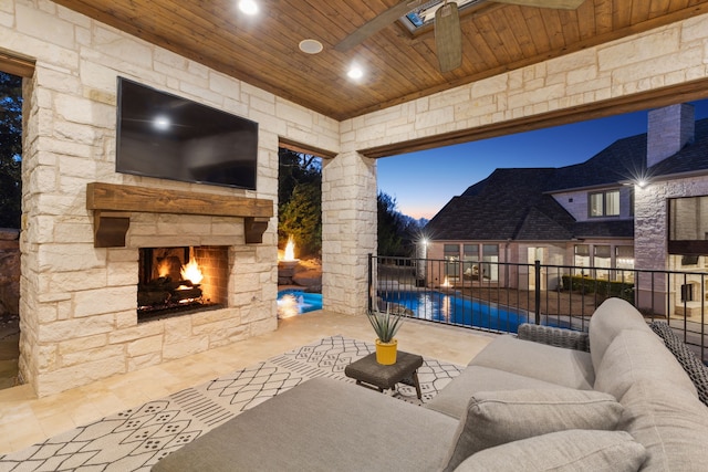 view of patio with fence and an outdoor living space with a fireplace