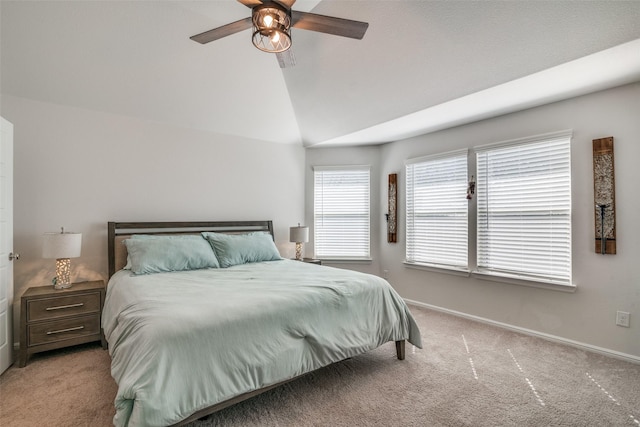 carpeted bedroom with vaulted ceiling, ceiling fan, and baseboards