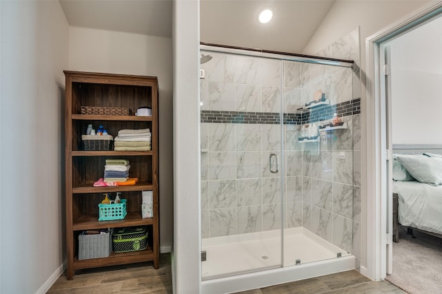 ensuite bathroom with a shower stall, baseboards, connected bathroom, and recessed lighting