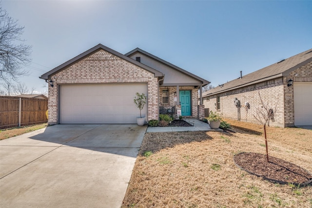 ranch-style home with a garage, driveway, brick siding, and fence