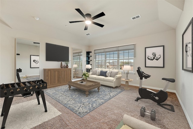 carpeted living area featuring baseboards, visible vents, and ceiling fan