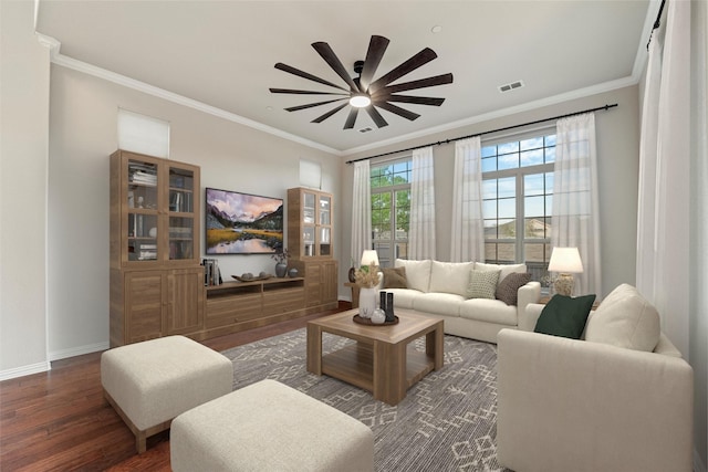 living room with visible vents, ornamental molding, ceiling fan, wood finished floors, and baseboards