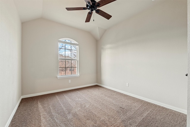 empty room featuring a ceiling fan, lofted ceiling, baseboards, and carpet