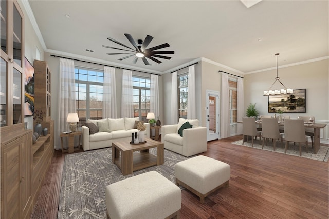 living room featuring ceiling fan, wood finished floors, visible vents, and crown molding