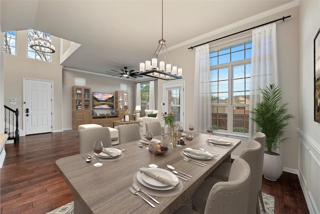 dining area with a chandelier, crown molding, baseboards, and dark wood-style floors