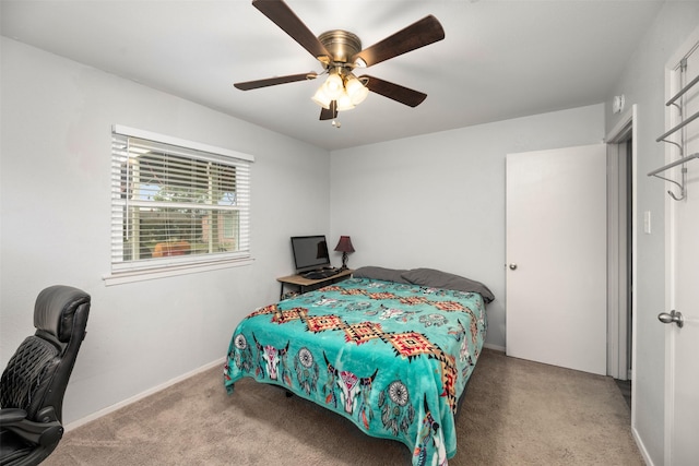 carpeted bedroom with ceiling fan and baseboards