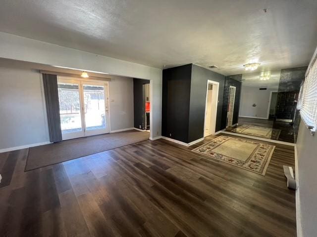 spare room with visible vents, baseboards, and wood finished floors