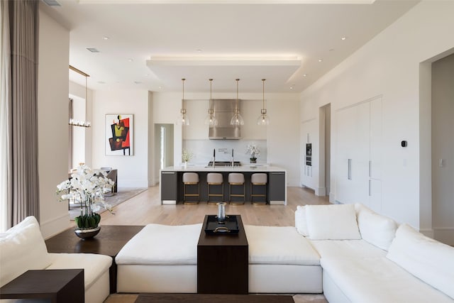 living room with light wood finished floors, recessed lighting, visible vents, and baseboards