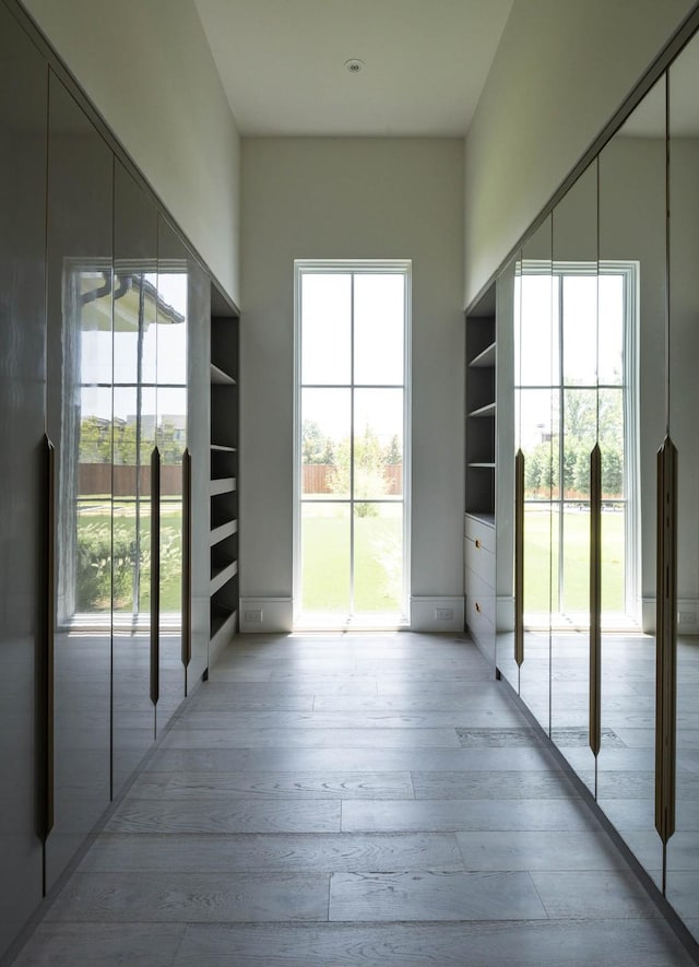 doorway to outside with plenty of natural light and wood finished floors