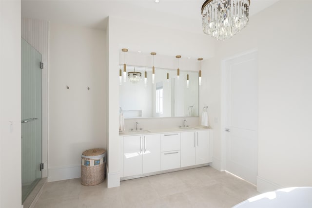 full bathroom with double vanity, a sink, and an inviting chandelier