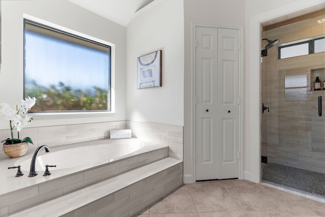 bathroom with a bath, a stall shower, a closet, and tile patterned floors