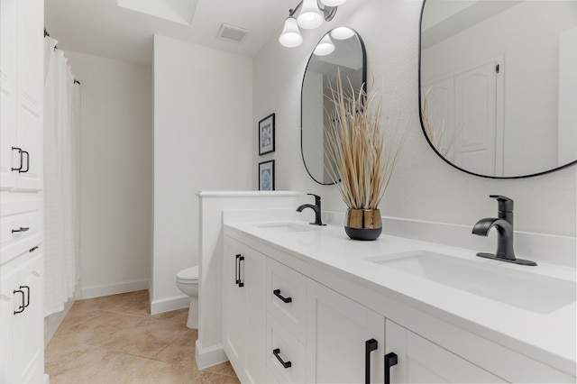 full bathroom with toilet, visible vents, a sink, and tile patterned floors