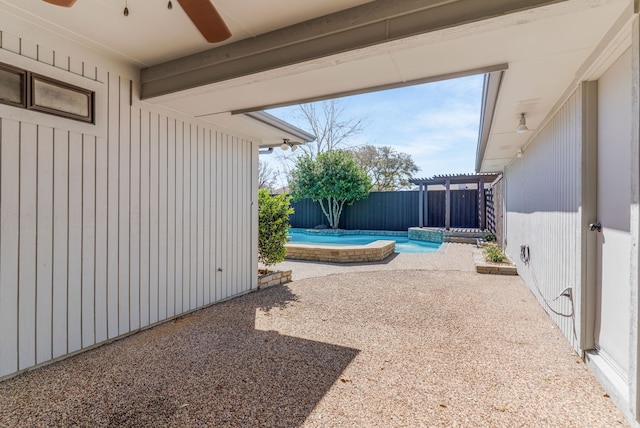 view of patio featuring a fenced backyard, a fenced in pool, and a ceiling fan