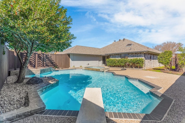 view of swimming pool featuring a fenced in pool, a patio area, an in ground hot tub, a fenced backyard, and a diving board