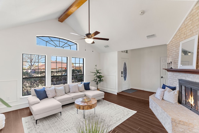 living area featuring high vaulted ceiling, a fireplace, visible vents, beam ceiling, and dark wood finished floors