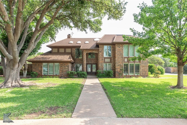 20 Glen Abbey St, Abilene, TX 79606 - view of front facade featuring a chimney, french doors, a tiled roof, and brick siding