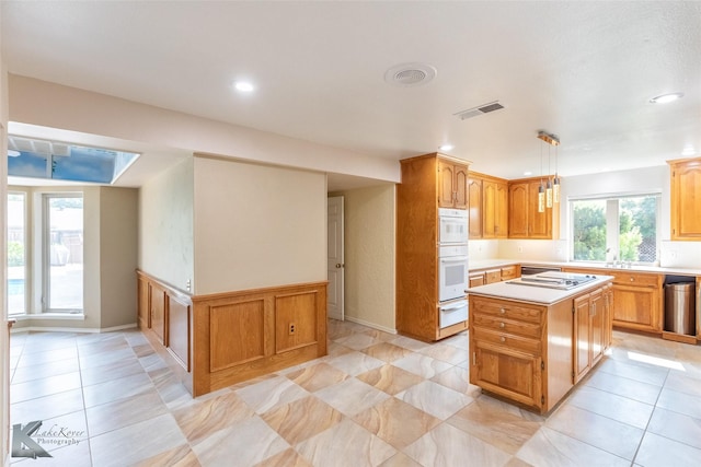 20 Glen Abbey St, Abilene, TX 79606 - kitchen featuring a warming drawer, light countertops, a center island, recessed lighting, and light tile patterned flooring