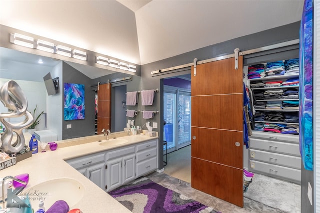 bathroom featuring lofted ceiling and vanity