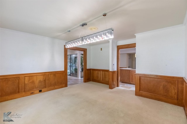 20 Glen Abbey St, Abilene, TX 79606 - unfurnished dining area featuring wainscoting, light colored carpet, crown molding, and wood walls