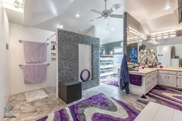 bathroom featuring a ceiling fan, lofted ceiling, vanity, and walk in shower