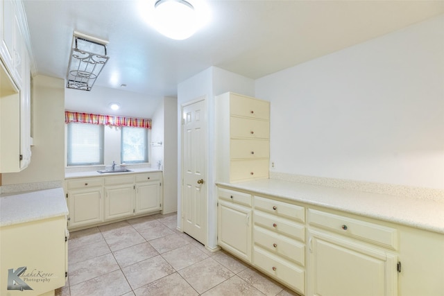 20 Glen Abbey St, Abilene, TX 79606 - kitchen featuring a sink, light tile patterned floors, and cream cabinets
