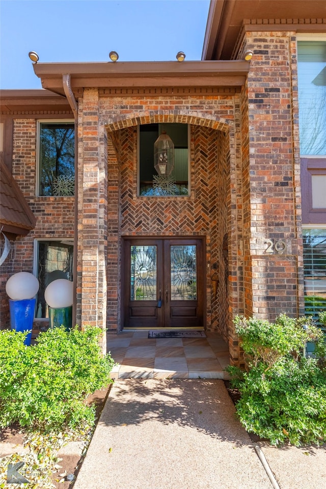 doorway to property with french doors and brick siding