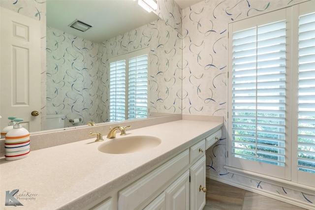 20 Glen Abbey St, Abilene, TX 79606 - bathroom with wallpapered walls, vanity, wood finished floors, and toilet