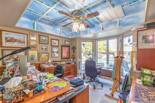 office area with light tile patterned floors and ceiling fan