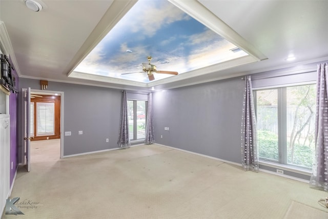20 Glen Abbey St, Abilene, TX 79606 - carpeted empty room with baseboards, plenty of natural light, a tray ceiling, a ceiling fan, and ornamental molding