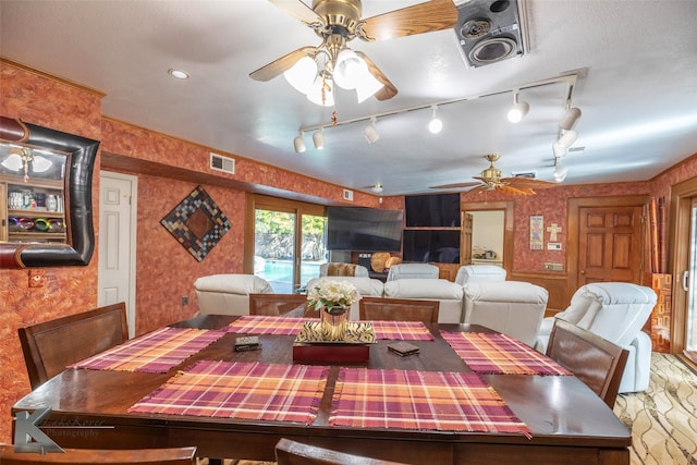 dining space featuring a ceiling fan, visible vents, and wallpapered walls