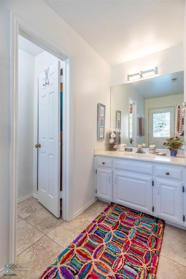 bathroom with vanity and baseboards