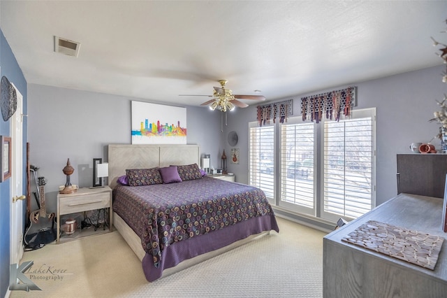 bedroom featuring carpet floors, visible vents, and a ceiling fan