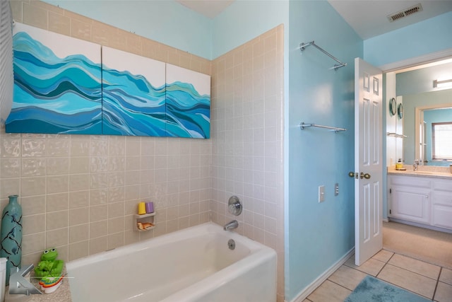 bathroom with a tub to relax in, visible vents, vanity, tile patterned flooring, and baseboards