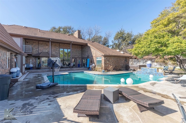 outdoor pool featuring a patio