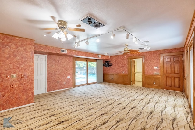 20 Glen Abbey St, Abilene, TX 79606 - unfurnished room with ceiling fan, rail lighting, wainscoting, and light colored carpet