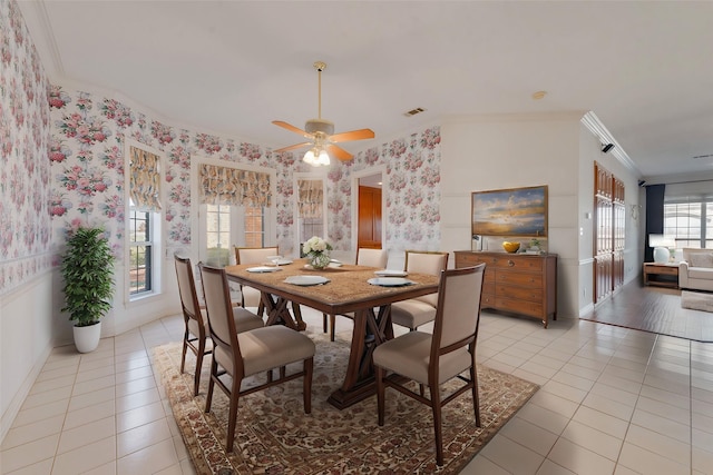 dining space with crown molding, light tile patterned flooring, baseboards, and wallpapered walls