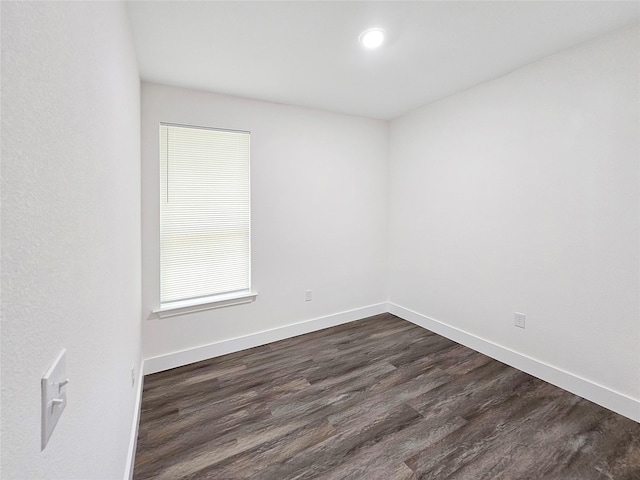 unfurnished room featuring dark wood finished floors and baseboards